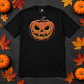 Black pumpkin graphic t-shirt laid flat with autumn accessories