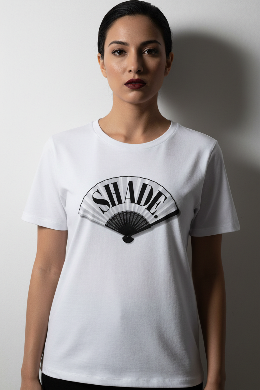 Editorial shot of Shade. hand fan tee against white wall, arms at sides